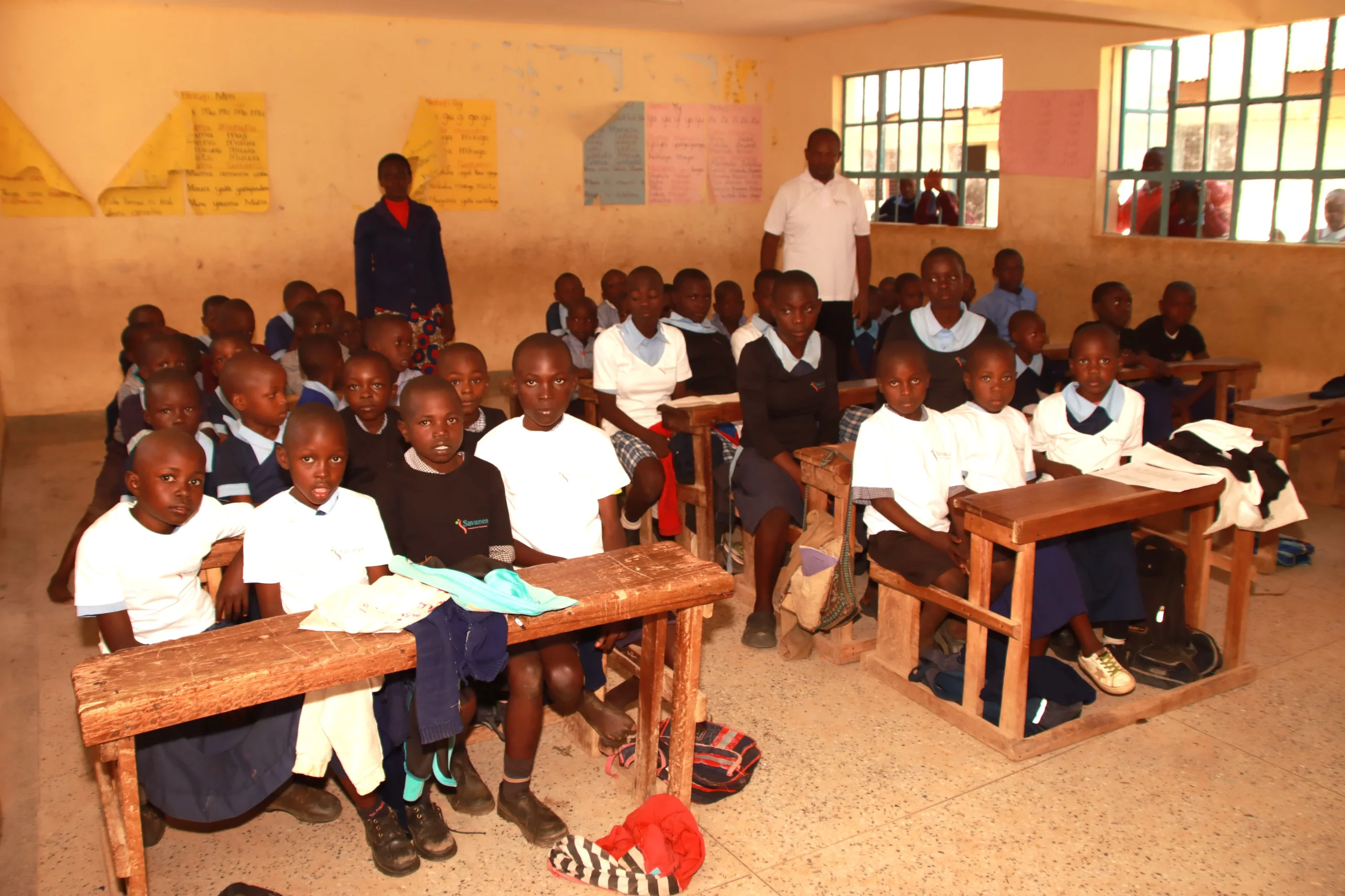 Savanes CBO distributing stationary to students.