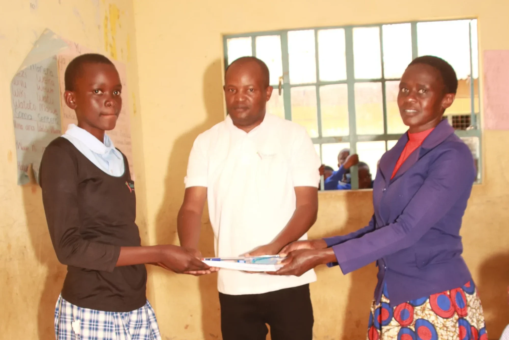 Savanes CBO distributing stationary to students.