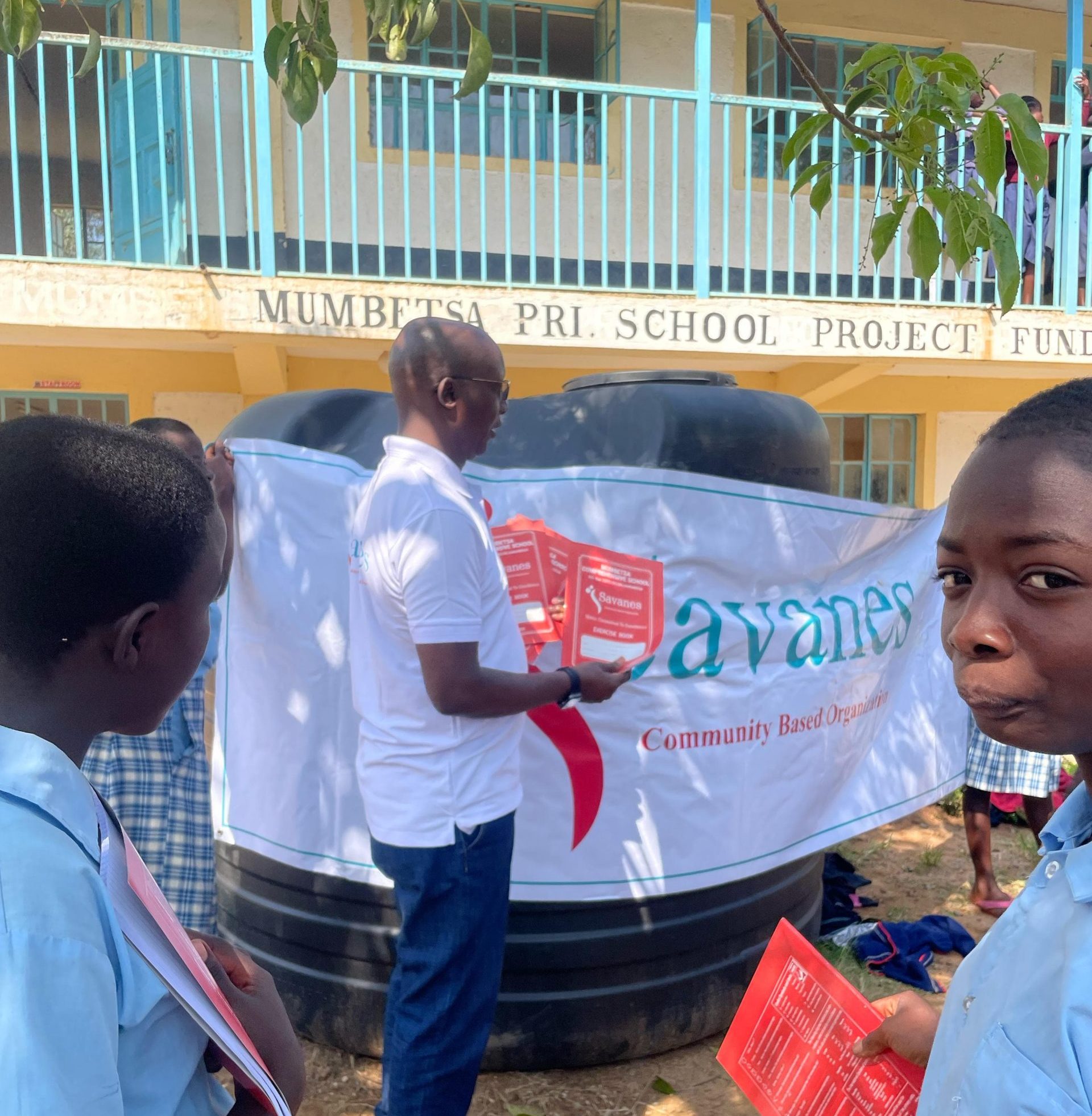 Savanes CBO distributing stationary at Mumbesta Primary and JSS.