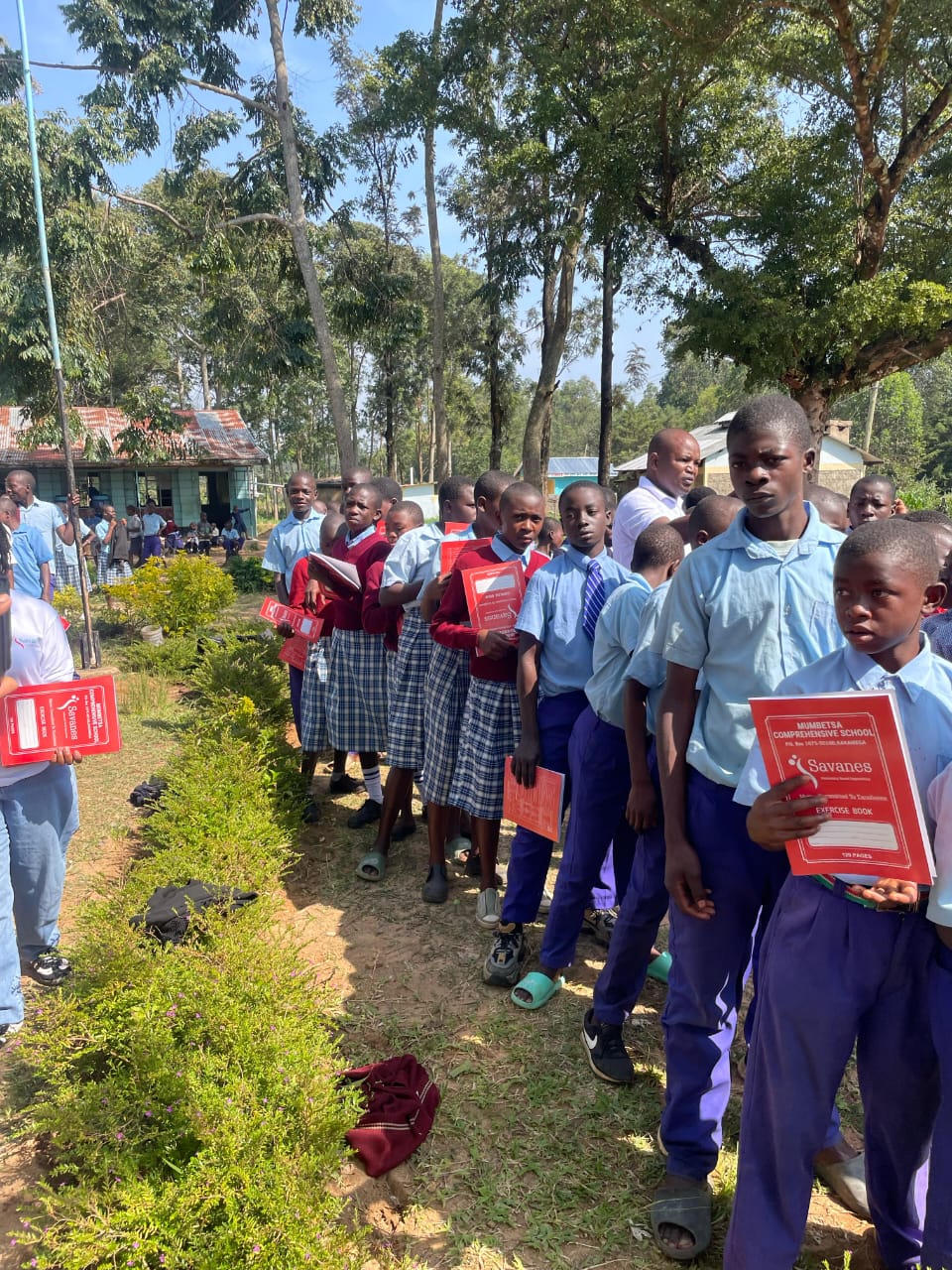 Savanes CBO distributing stationary at Imulana Primary and JSS